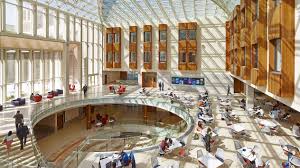 a large building with glass walls and a circular staircase